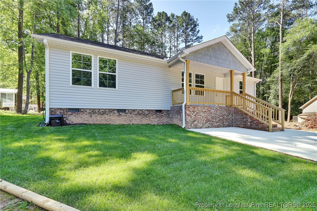 1036 Meadow Reach Sanford, NC 27332 - Photo 3 of 30 a view of a house with a yard and potted plants