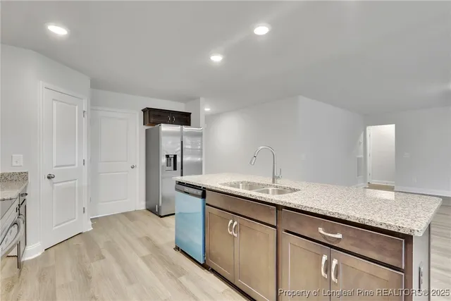a kitchen with a sink stove and refrigerator