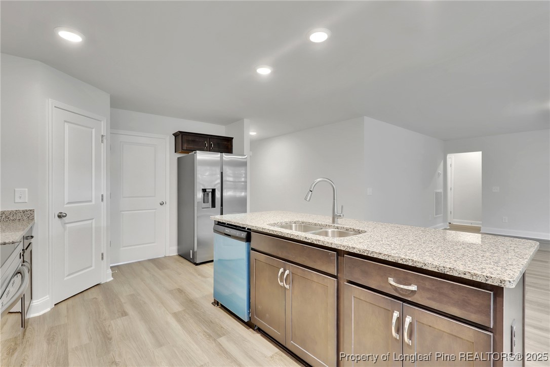 1036 Meadow Reach Sanford, NC 27332 - Photo 6 of 30 a kitchen with a sink stove and refrigerator