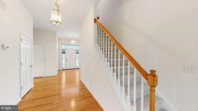 a spacious bathroom with a double vanity sink a mirror and a toilet