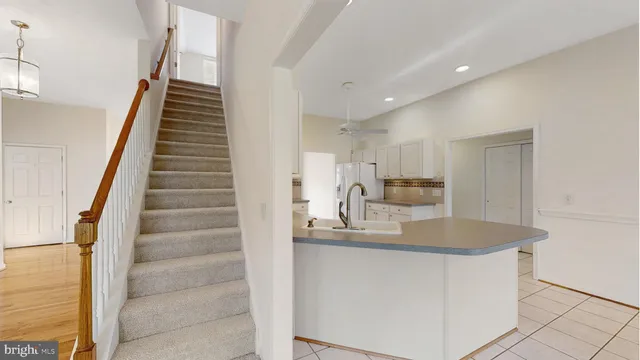 a view of a room with a ceiling fan and window