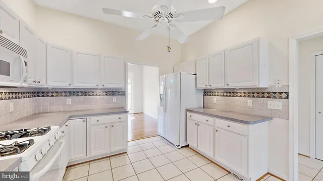 a kitchen with a sink cabinets and appliances