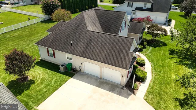 an aerial view of residential houses with outdoor space and swimming pool