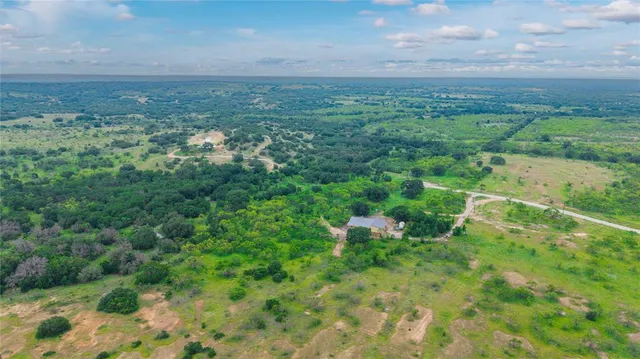 a view of a big yard with lots of green space