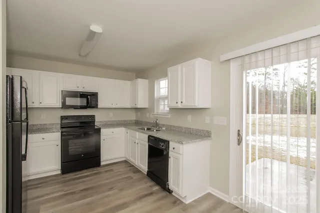 a kitchen with a sink stainless steel appliances and cabinets