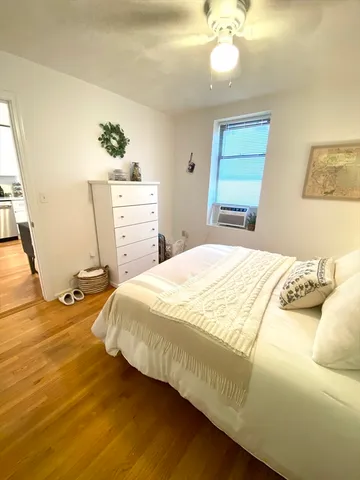 a bedroom with a bed and window