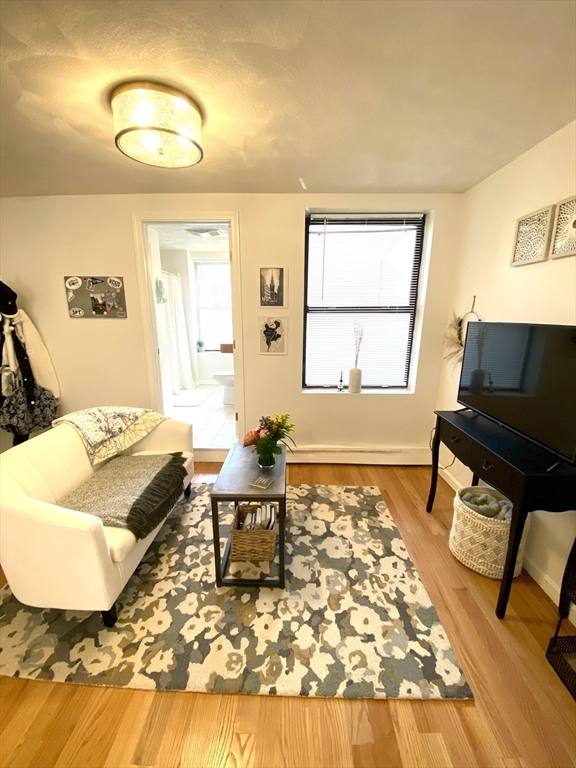 24 Charter Street, Unit 3 Boston, MA 02113 - Photo 7 of 9 a living room with furniture and a flat screen tv