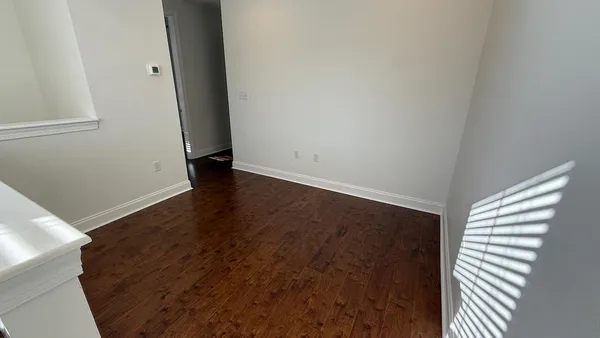 a view of a room with wooden floor and cabinet