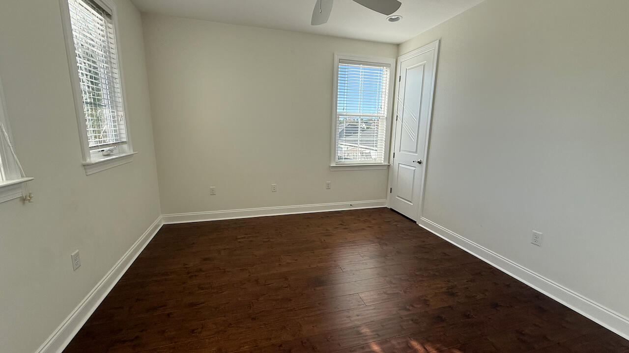 143 Christian Drive Santa Rosa Beach, FL 32459 - Photo 21 of 25 an empty room with wooden floor and windows