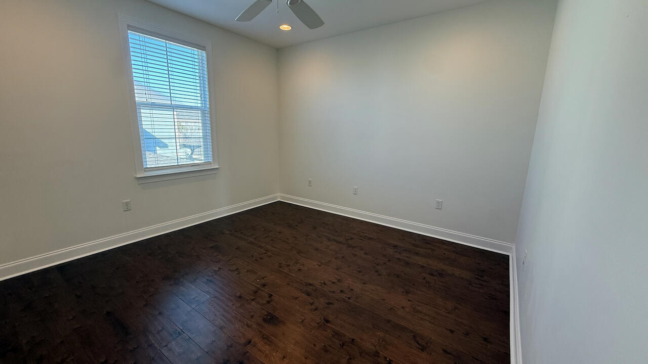 143 Christian Drive Santa Rosa Beach, FL 32459 - Photo 24 of 25 an empty room with wooden floor and windows