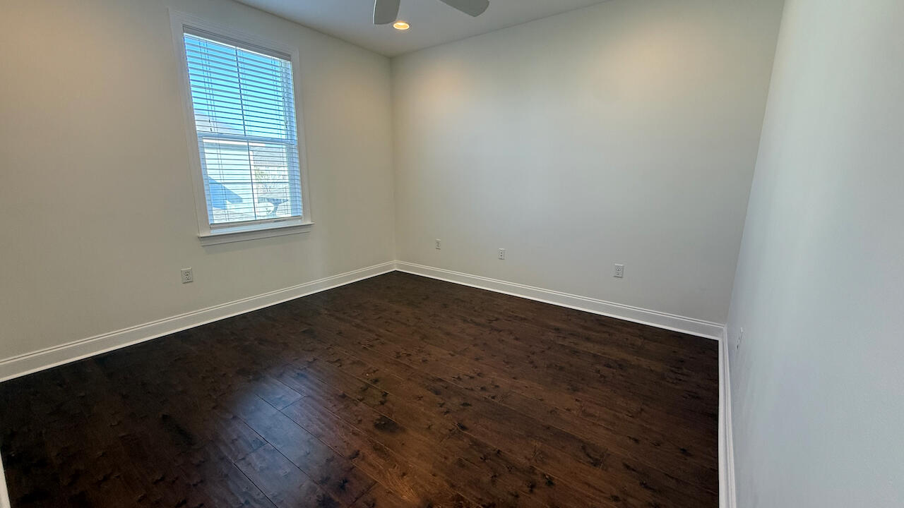 143 Christian Drive Santa Rosa Beach, FL 32459 - Photo 25 of 25 an empty room with wooden floor and windows