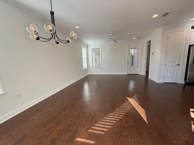 a view of a room with wooden floor and windows
