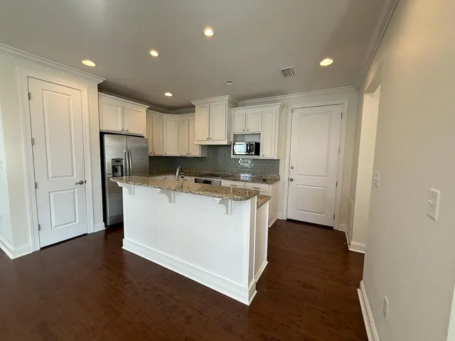 a kitchen with stainless steel appliances granite countertop a refrigerator sink and cabinets