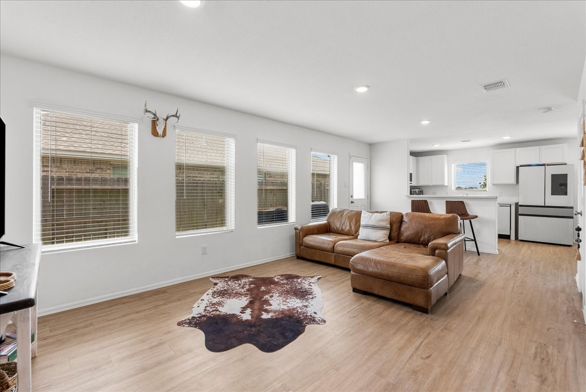 14410 Boyton Holw Trace Rosharon, TX 77583 - Photo 9 of 35 Dislike enclosed rooms with no views? No worries, this home has an abundance of natural lighting beaming throughout. Luxe LVP flooring runs consistently through the first level and all wet areas.