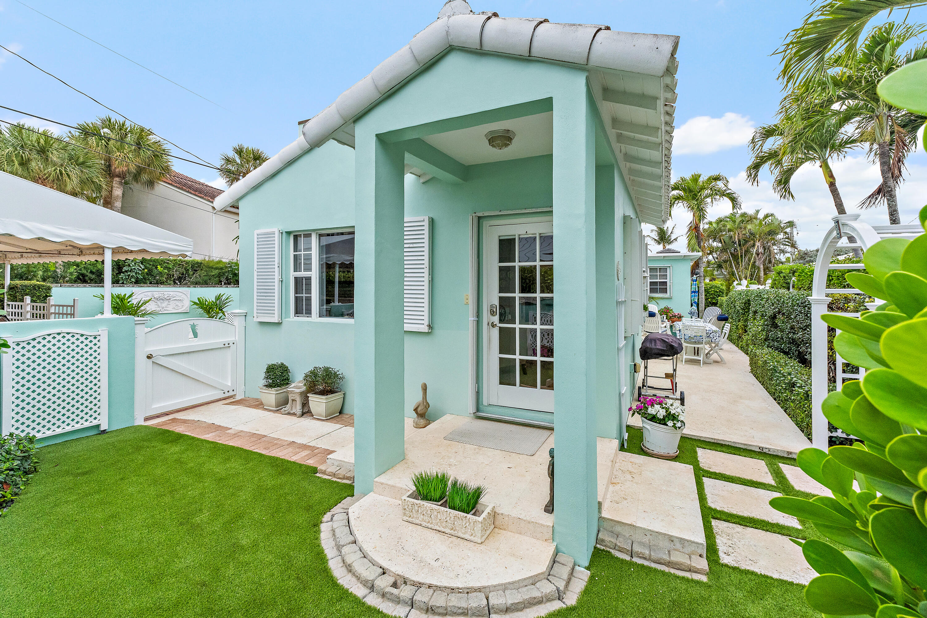 240 Celestial Way, Unit 2 Juno Beach, FL 33408 - Photo 3 of 59 a front view of a house with garden