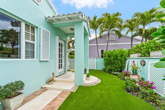 a living room with furniture a fireplace and paintings on the wall