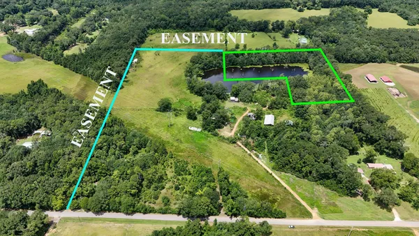 an aerial view of residential houses with outdoor space and street view