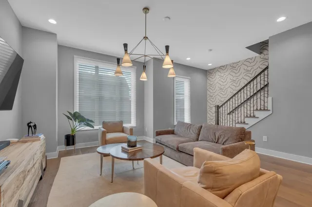 a living room with furniture a ceiling fan and a window
