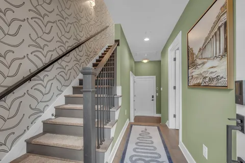 a view of a hallway with wooden floor and entryway
