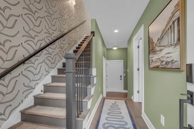a view of a hallway with wooden floor and entryway