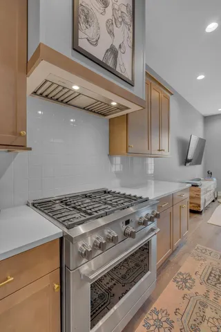 a white stove top oven sitting inside of a kitchen