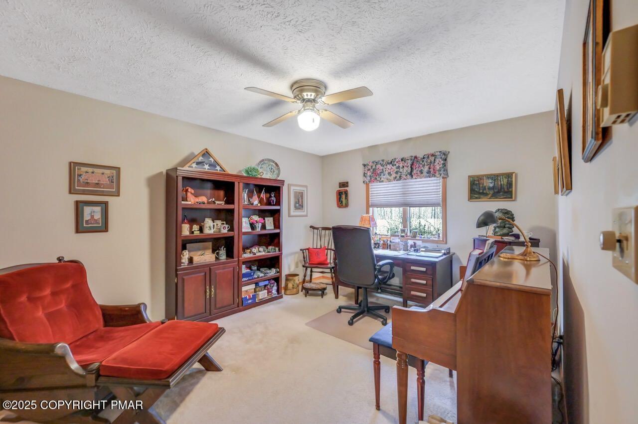 183 Panther Run Road Jim Thorpe, PA 18229 - Photo 25 of 59 a living room with furniture a bookshelf and a window