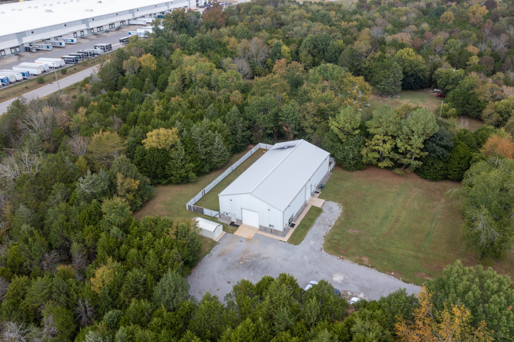 an aerial view of a house with a yard and lake view