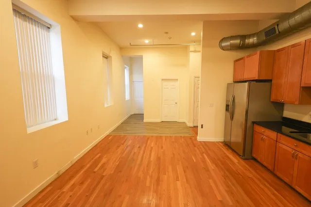 a view of a kitchen with wooden floor and a sink