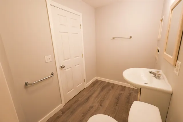 a bathroom with a sink mirror and toilet