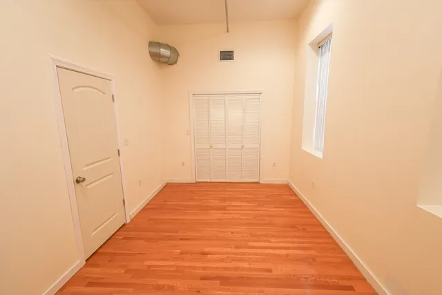a view of a room with wooden floor