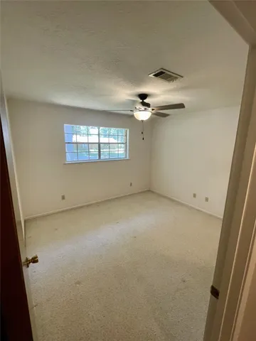 an empty room with a empty space and windows