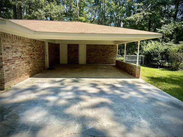 a view of a white house with a big yard and large tree