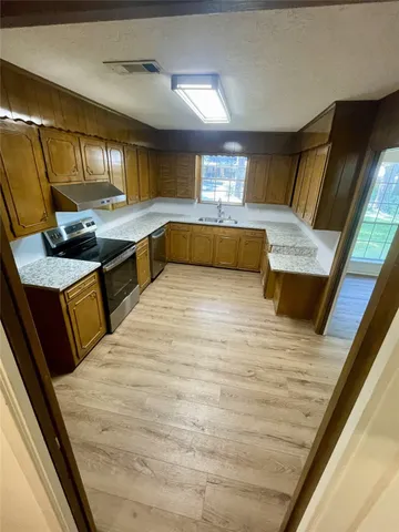 a large white kitchen with a large window