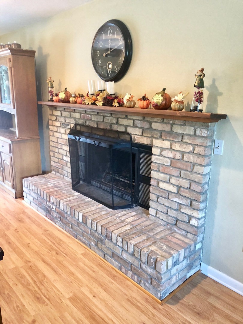 374 Rock Island Road Dixon, IL 61021 - Photo 6 of 20 a living room with a fireplace and a wooden floor