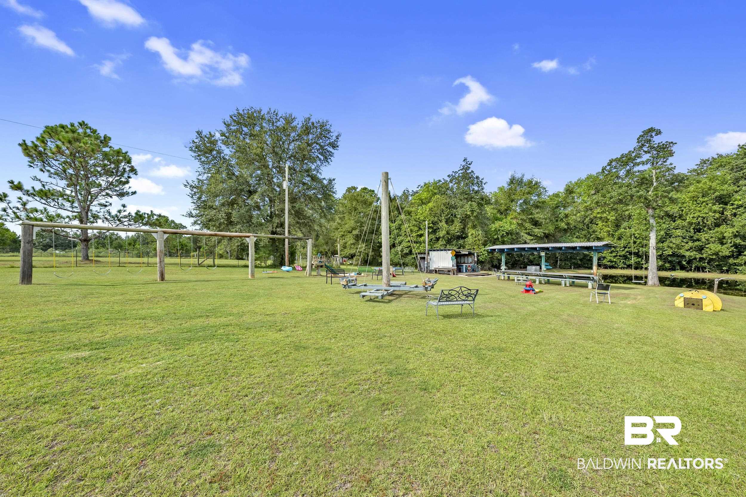 22823 Lanier Road Robertsdale, AL 36567 - Photo 24 of 46 View of property's community with a lawn and view of wooded area