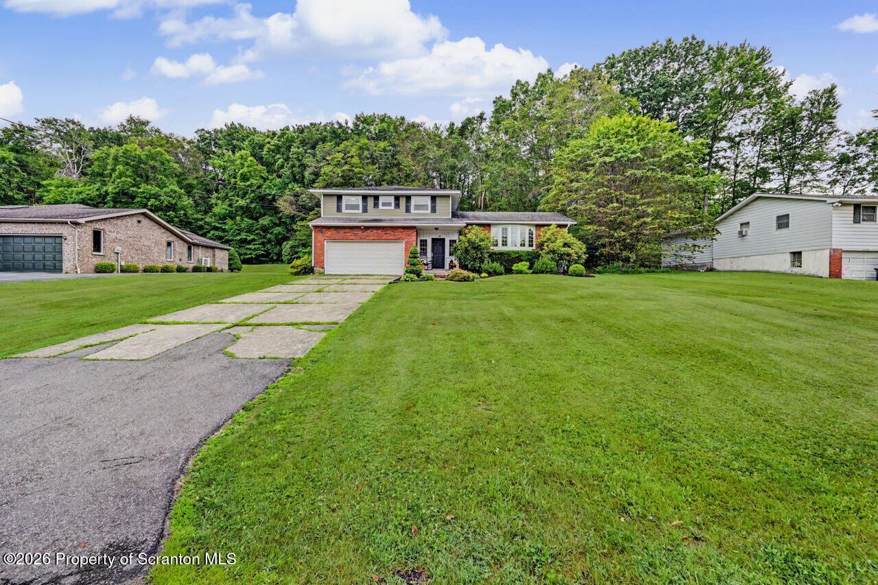 121 T Rt 351 Moscow, PA 18444 - Photo 74 of 79 a front view of a house with a yard and garage
