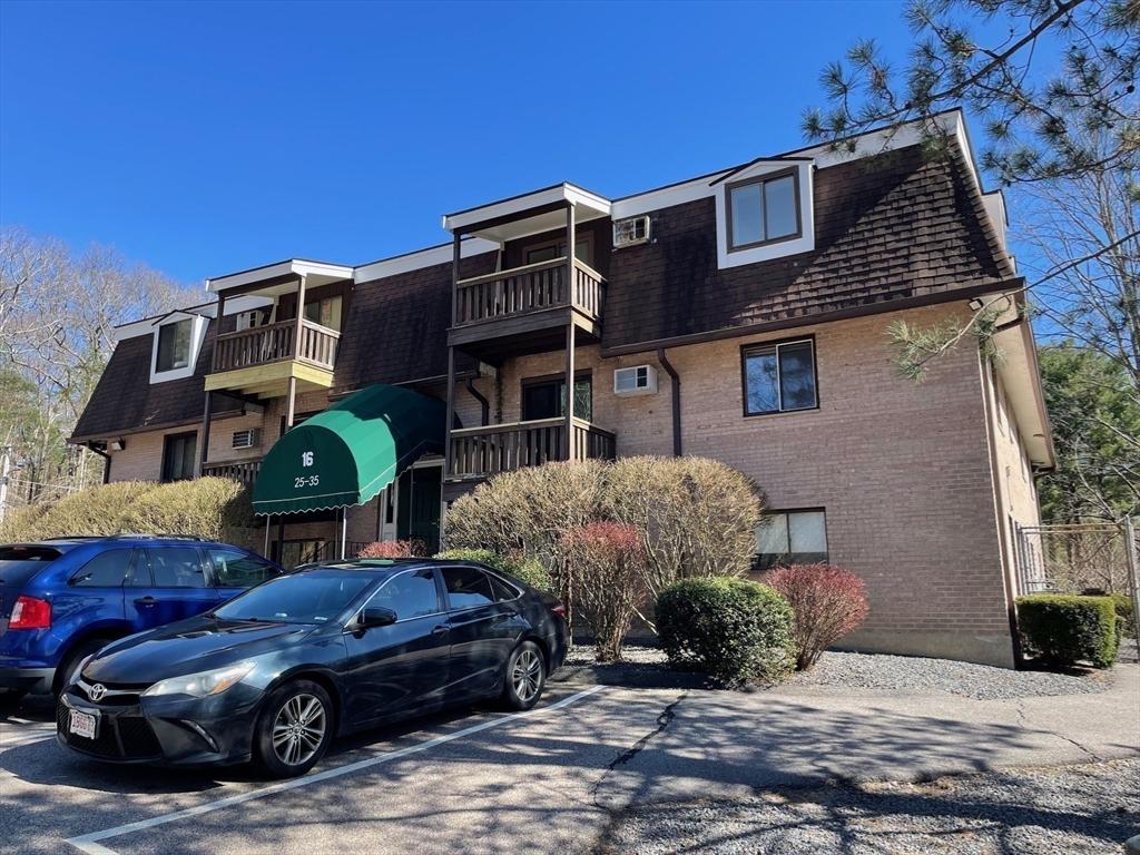 a front view of a house with parking space