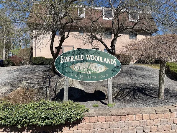 a sign board with a bench in front of the house