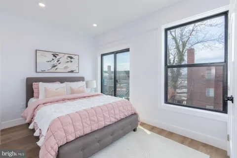 a bedroom with a large bed and a window