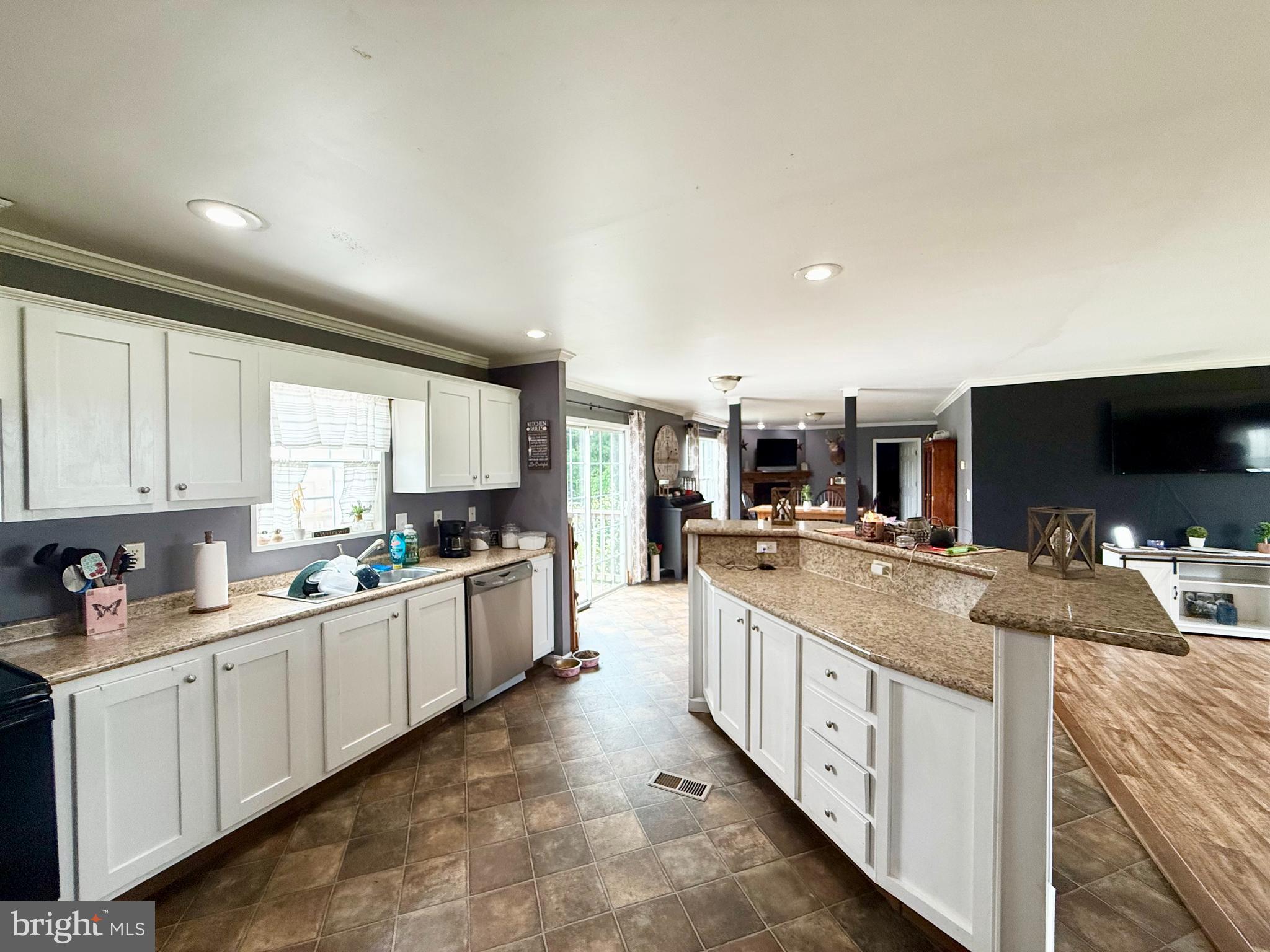 35777 Cobbs Hill Road Willards, MD 21874 - Photo 15 of 46 a large kitchen with kitchen island granite countertop a sink and cabinets