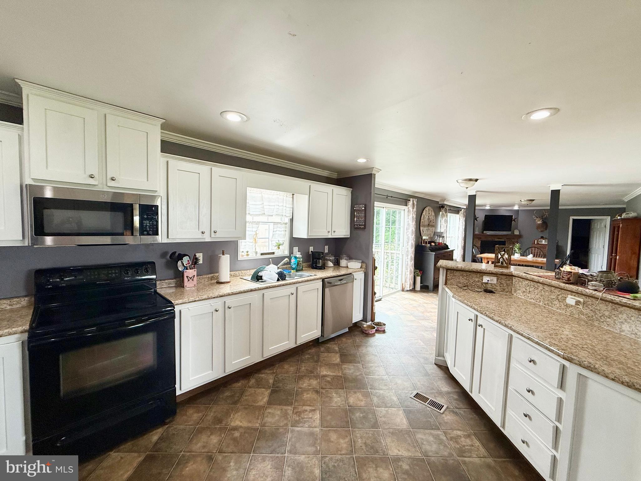 35777 Cobbs Hill Road Willards, MD 21874 - Photo 16 of 46 a large kitchen with stainless steel appliances granite countertop a stove and a sink