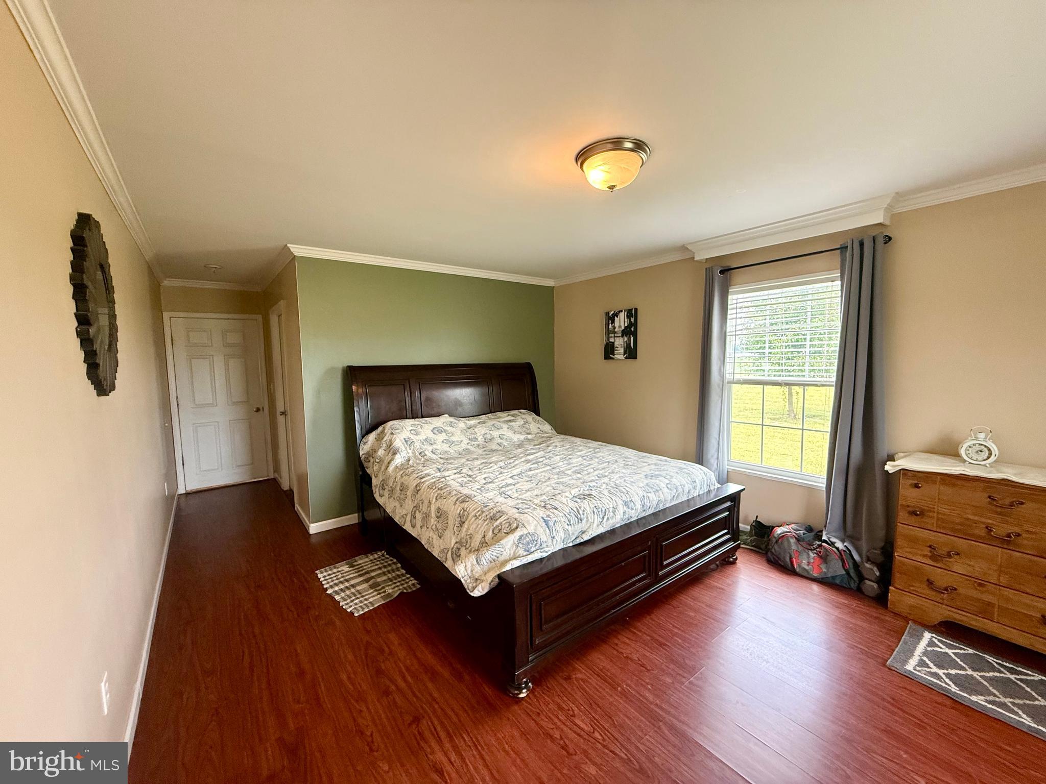 35777 Cobbs Hill Road Willards, MD 21874 - Photo 19 of 46 a bedroom with a bed and wooden floor