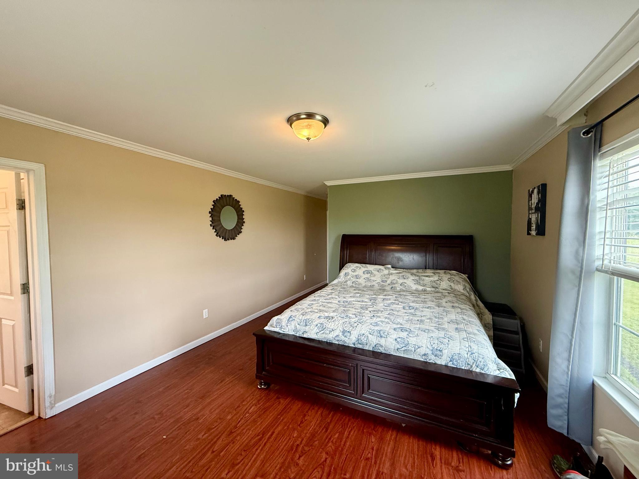 35777 Cobbs Hill Road Willards, MD 21874 - Photo 20 of 46 a bed sitting in a bedroom next to a window