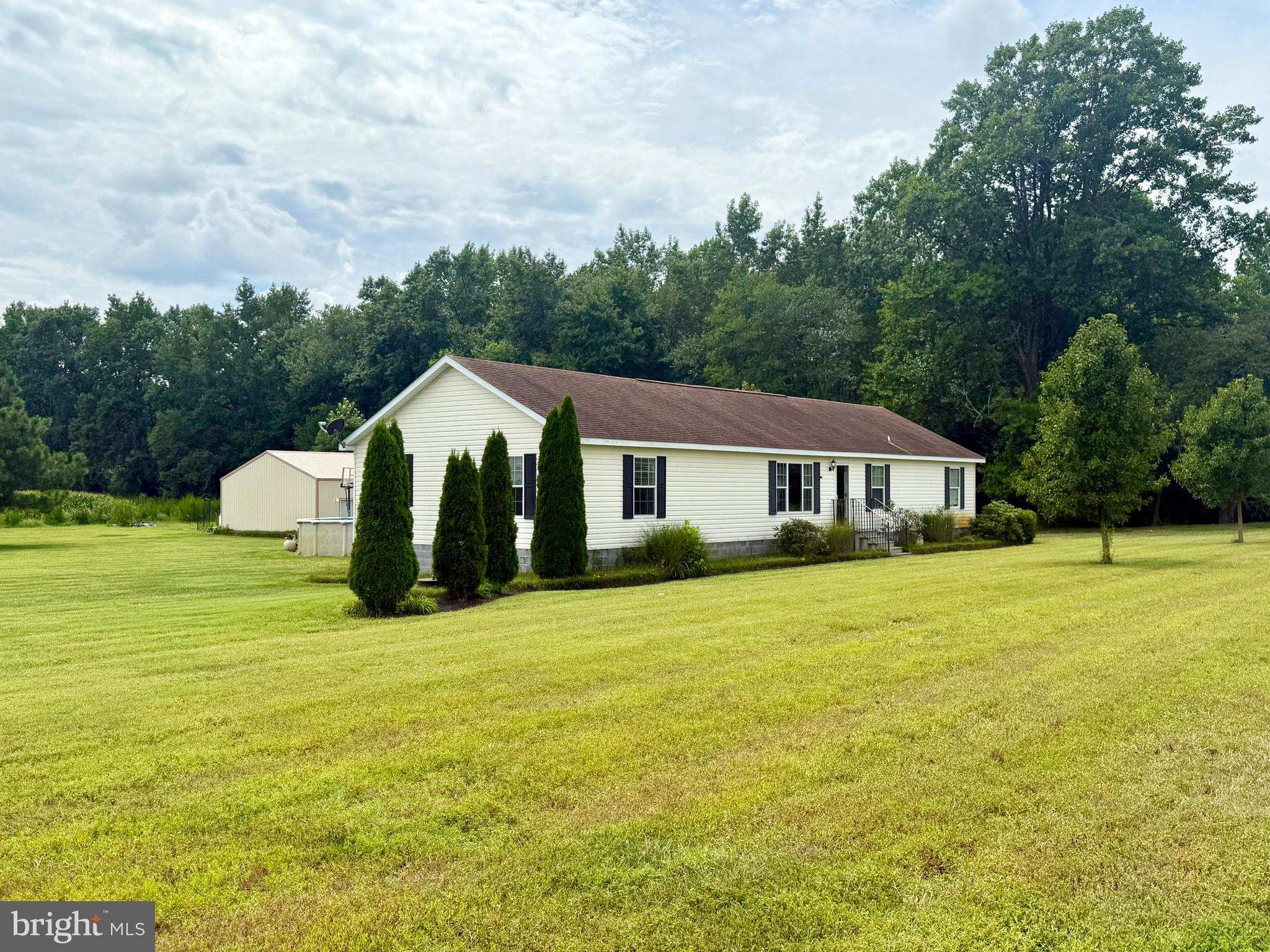 35777 Cobbs Hill Road Willards, MD 21874 - Photo 2 of 46 a front view of a house with a garden and trees