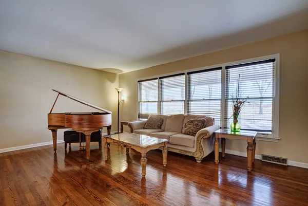 a living room with furniture and a wooden floor