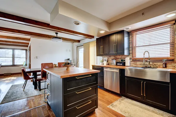 a kitchen with stainless steel appliances granite countertop a stove and a refrigerator