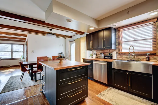 a kitchen with stainless steel appliances granite countertop a stove and a refrigerator