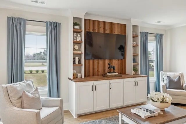 a living room with furniture and a flat screen tv
