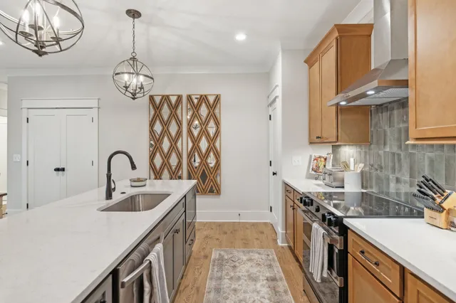 a view of a hallway with wooden floor and entryway
