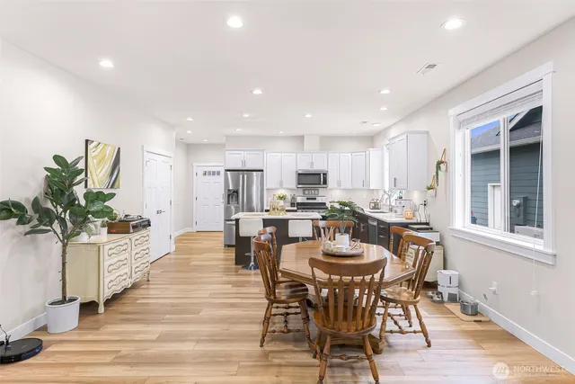 a view of a dining room with furniture and wooden floor